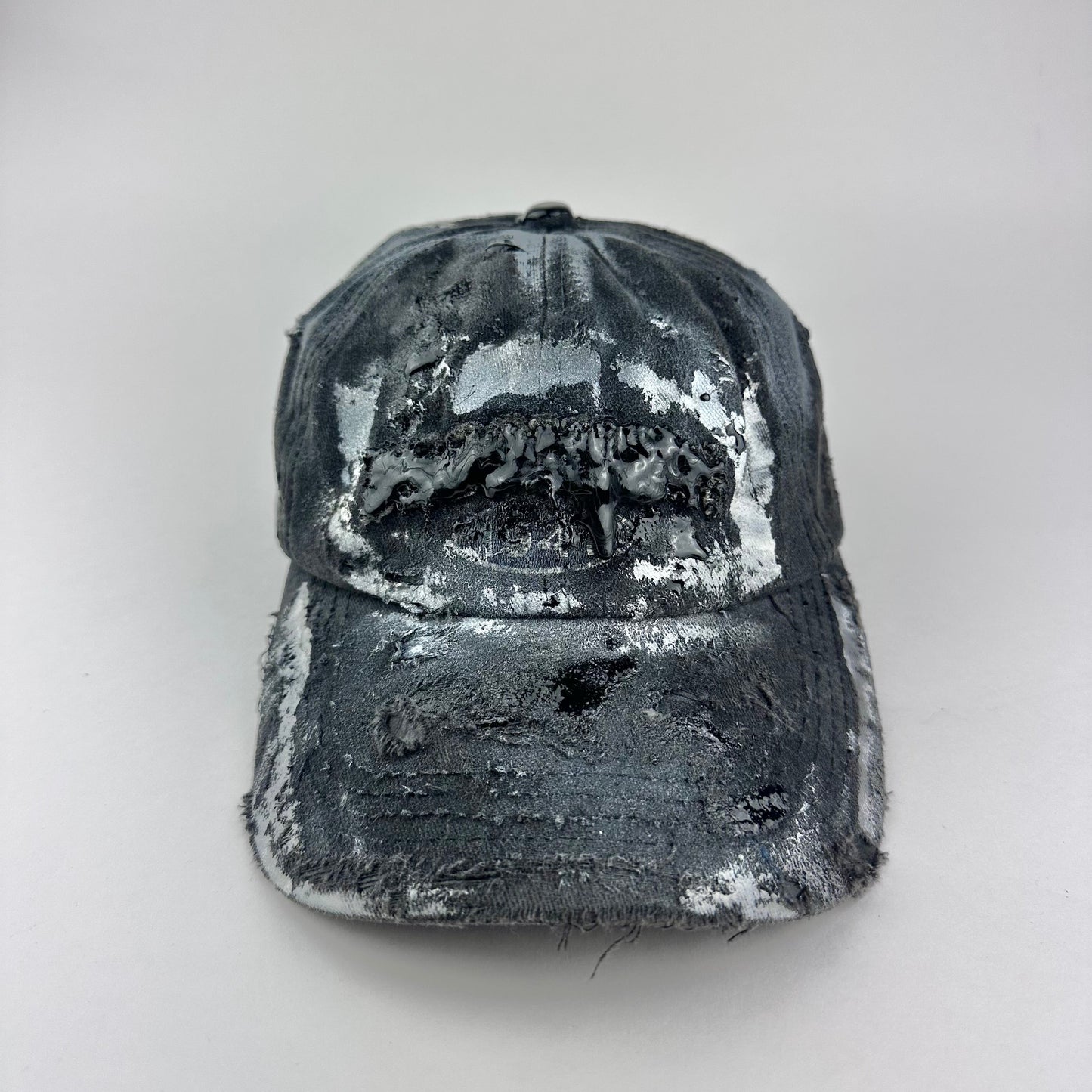 Overview of ASTROBOI* Brooklyn distressed black baseball hat with 3D black resin slime over embroidery and adjustable back strap, handmade in NYC.