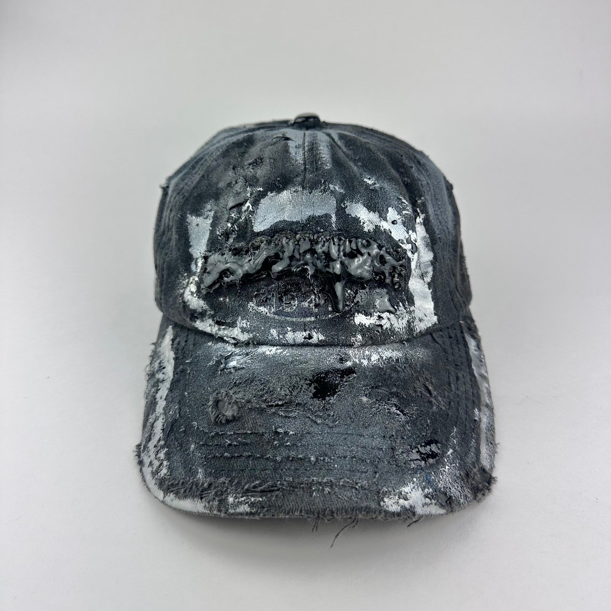 Overview of ASTROBOI* Brooklyn distressed black baseball hat with 3D black resin slime over embroidery and adjustable back strap, handmade in NYC.