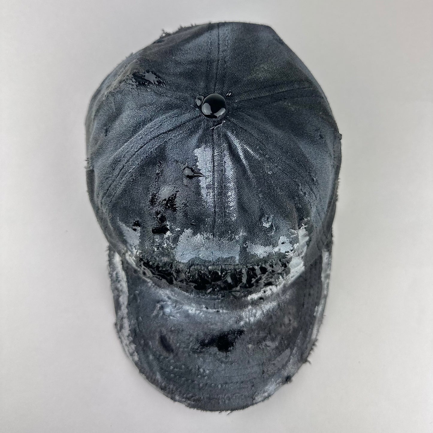 Top of ASTROBOI* Brooklyn distressed black baseball hat with 3D black resin slime over embroidery and adjustable back strap, handmade in NYC.