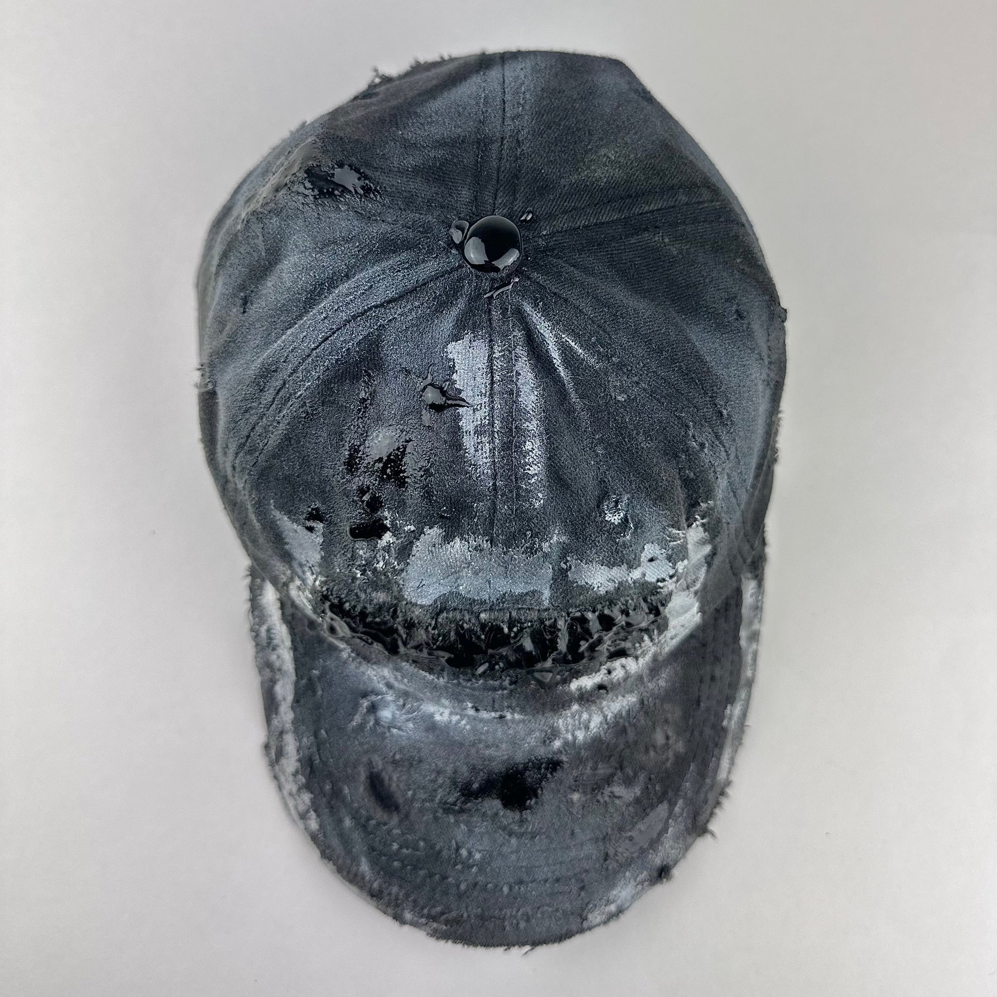 Top of ASTROBOI* Brooklyn distressed black baseball hat with 3D black resin slime over embroidery and adjustable back strap, handmade in NYC.