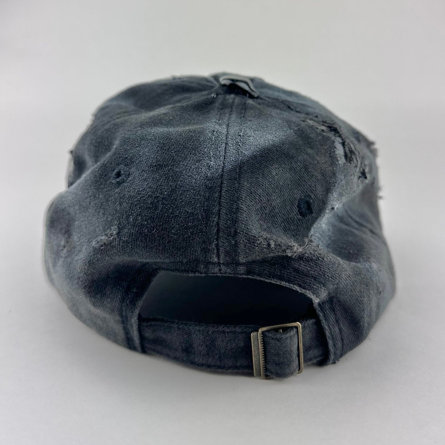 Back of ASTROBOI* Brooklyn distressed black baseball hat with 3D black resin slime over embroidery and adjustable back strap, handmade in NYC.