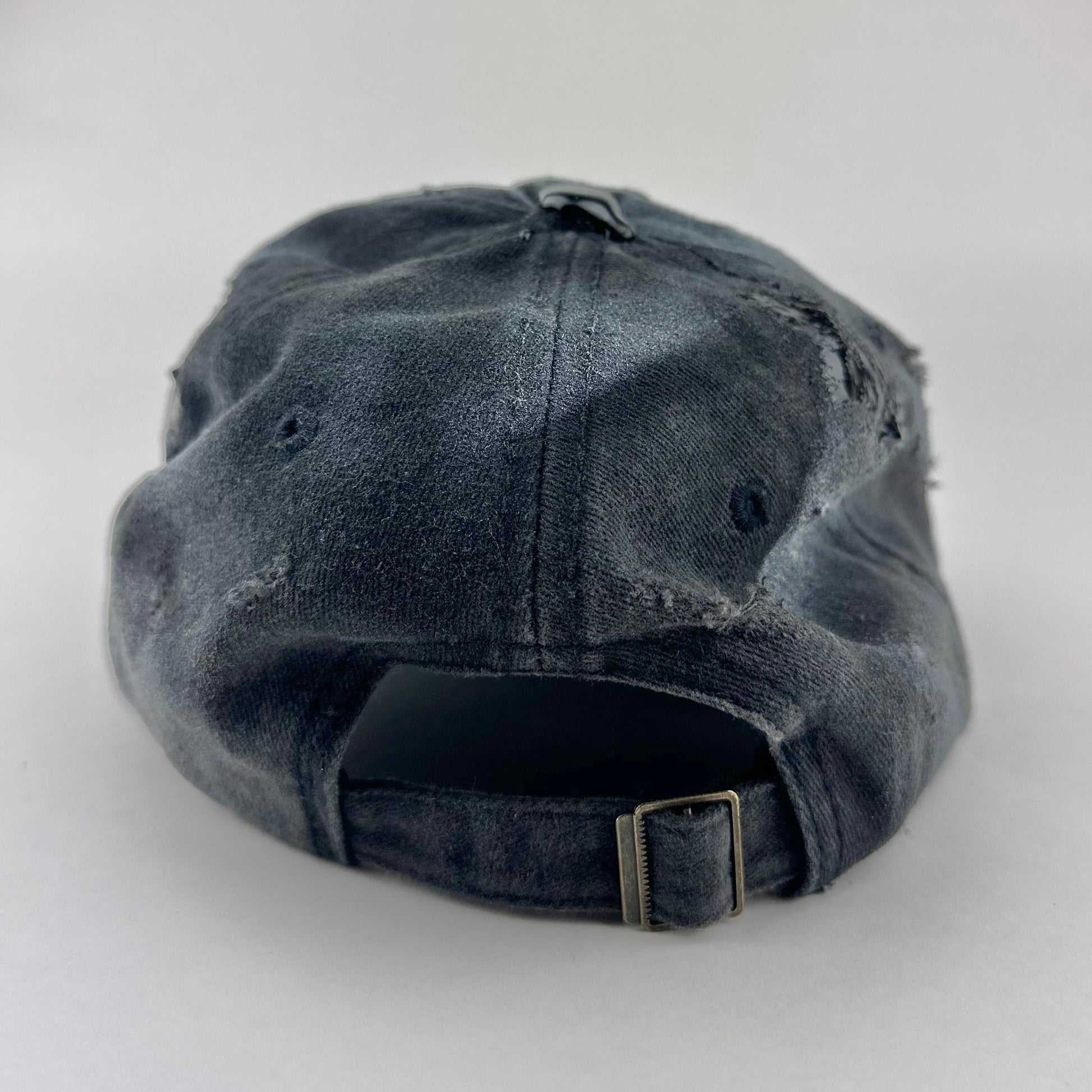 Back of ASTROBOI* Brooklyn distressed black baseball hat with 3D black resin slime over embroidery and adjustable back strap, handmade in NYC.