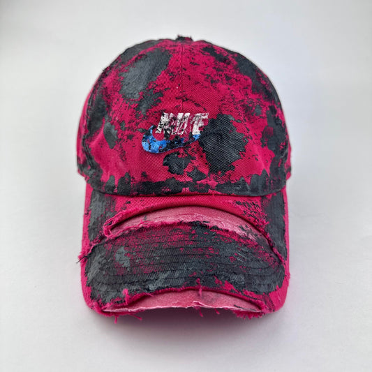 ASTROBOI* x Nike 'Comet' red and black painted distressed hat with Nike logo at center front and black painted pattern throughout, front view.