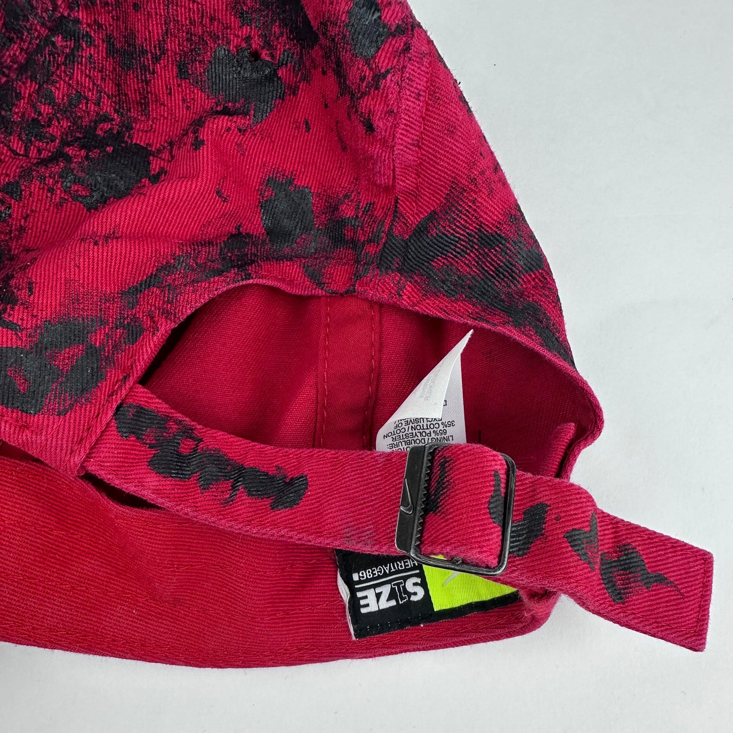 ASTROBOI* x Nike 'Comet' red and black painted distressed hat, rear view showing adjustable back and distressed finish.