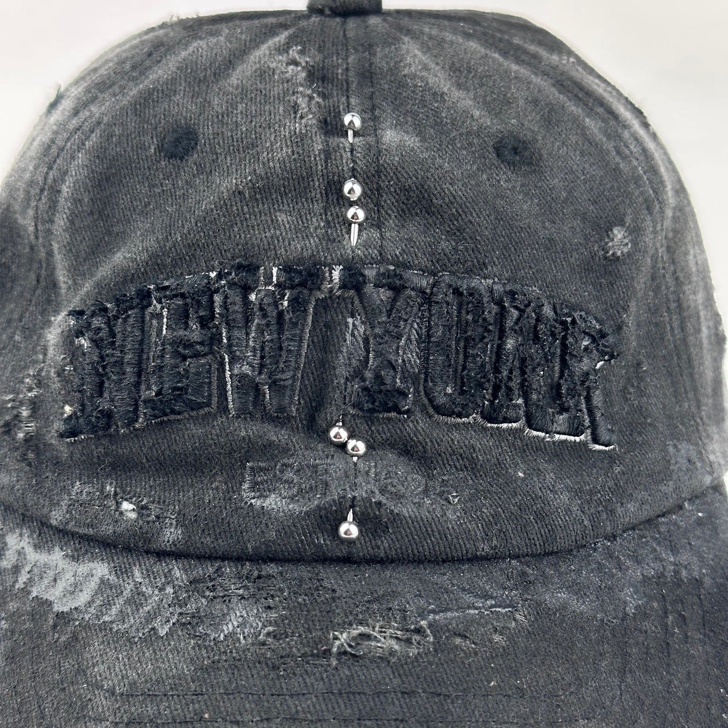 'Kinky' New York Black Distressed Pierced Half Visor Hat