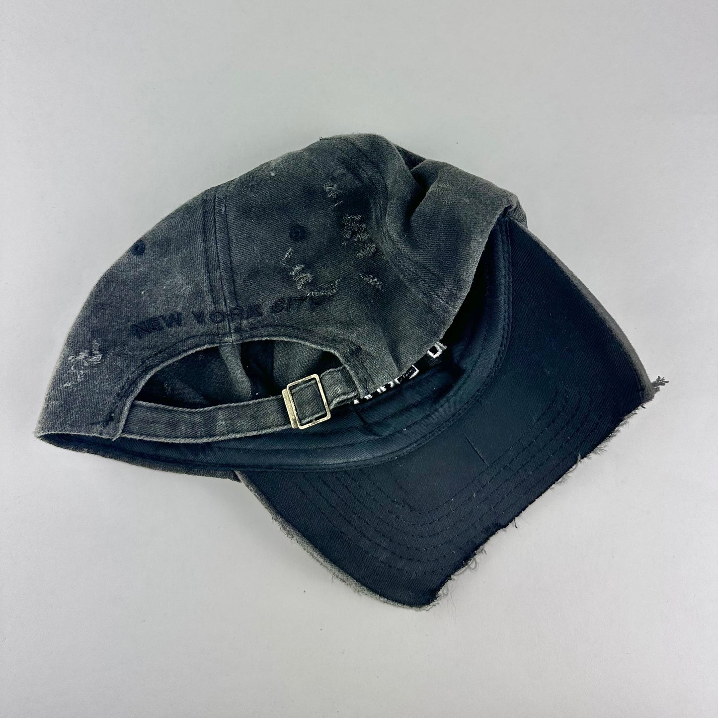 'Kinky' New York Black Distressed Pierced Half Visor Hat