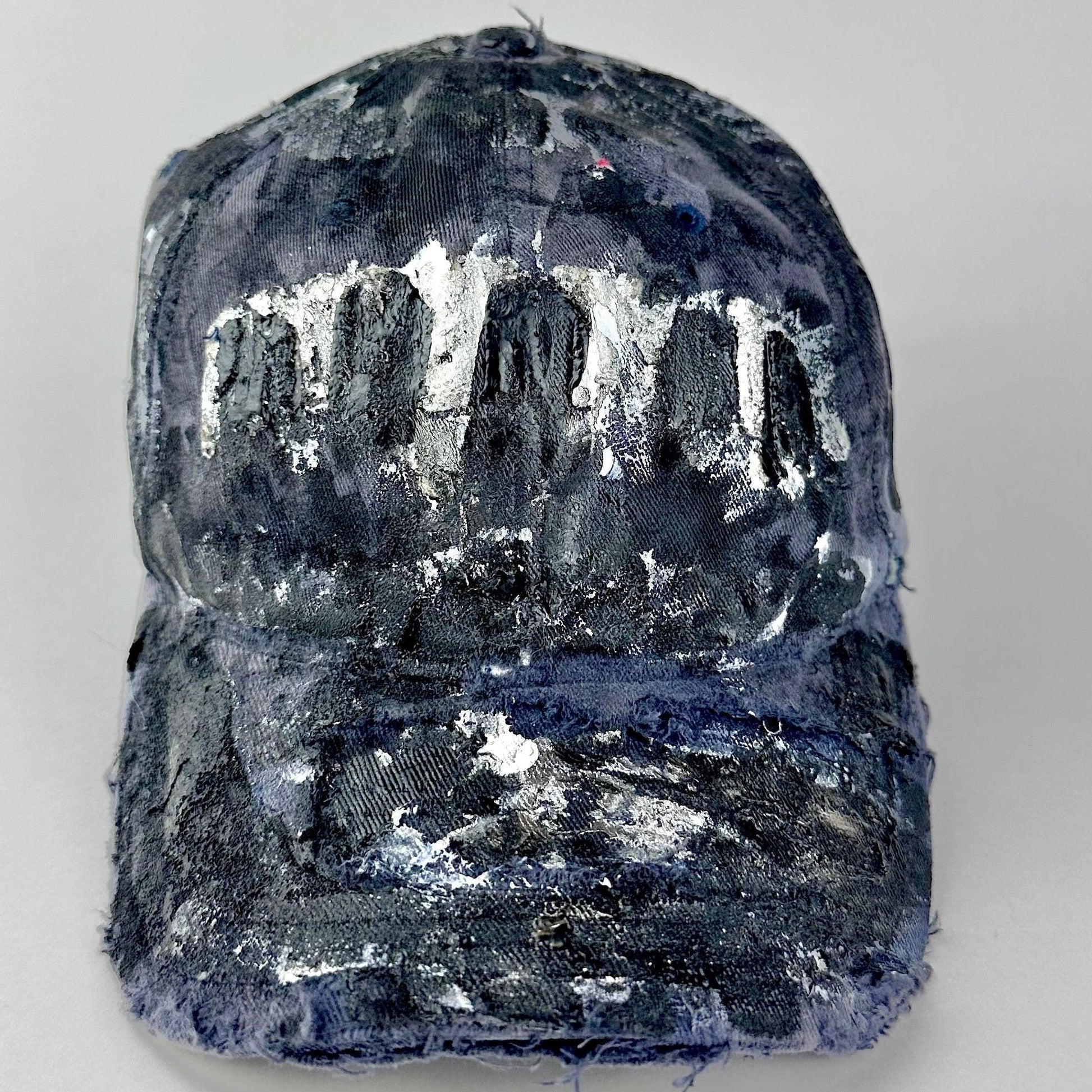 Overview of ASTROBOI* navy fitted cap with custom black, white, and silver paint and distressed vintage finish.