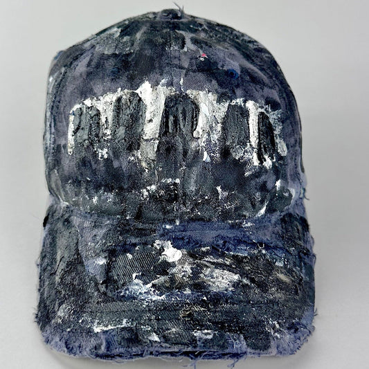 Overview of ASTROBOI* navy fitted cap with custom black, white, and silver paint and distressed vintage finish.