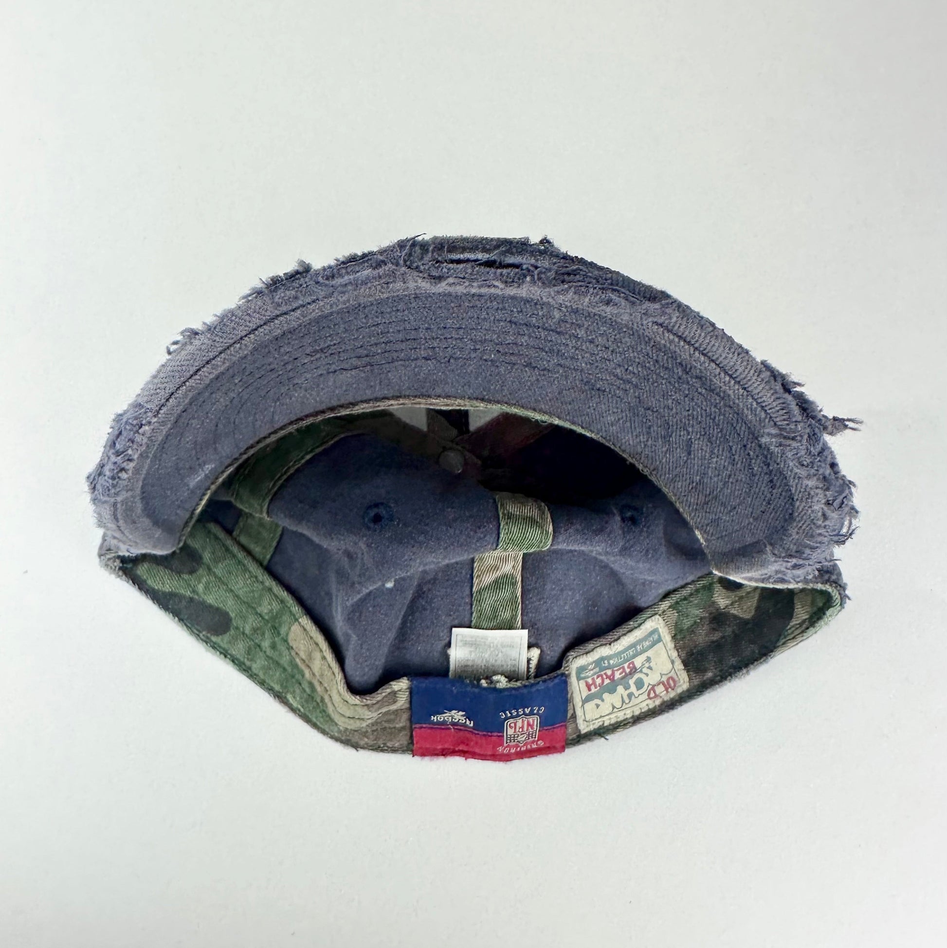 Back of ASTROBOI* navy fitted cap with custom black, white, and silver paint and distressed vintage finish.