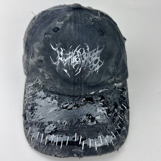 Cover image of ASTROBOI* Stitched Up black distressed hat with silver staples sealed in resin, indie logo, and custom paint, handmade in NYC.