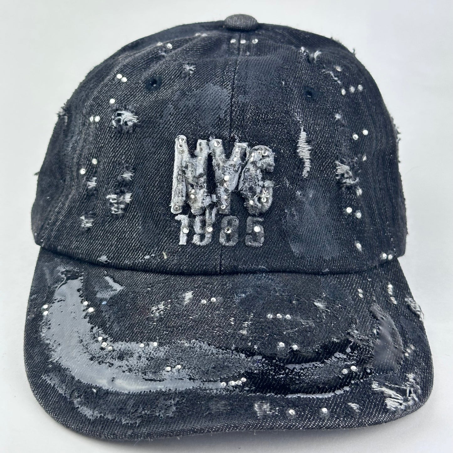 Close up of New York Black Distressed Denim Resin & Rhinestone Hat