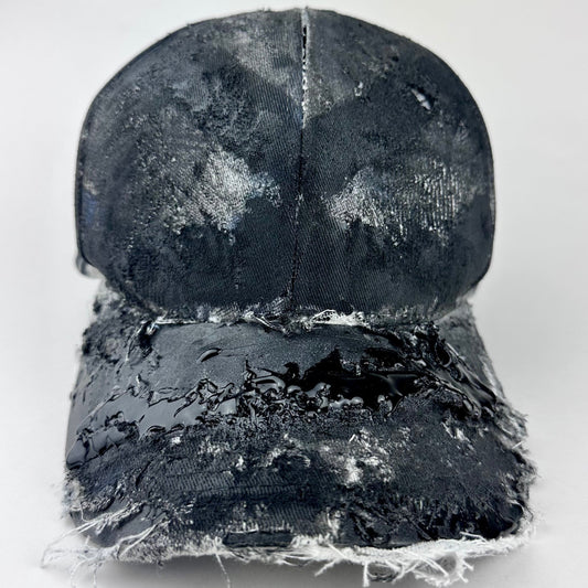 Front of ASTROBOI* blue trompe l’oeil denim print hat with black paint treatment, distressed texture and glossy black resin visor accents.