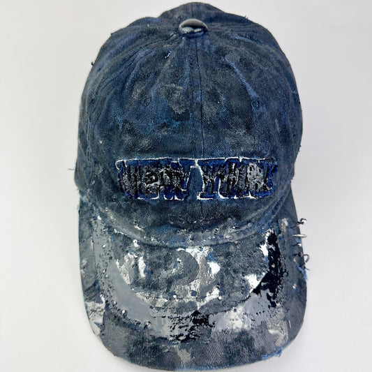 Front of ASTROBOI* Zypher NYC navy distressed hat with metallic silver paint, black resin logo and brim, adjustable back streetwear cap.