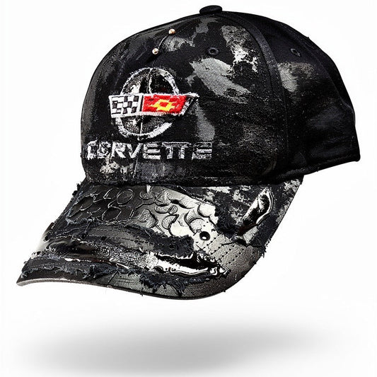 3D image of “Black distressed ASTROBOI* x Corvette hat with resin-coated logo, stainless steel piercings, and deconstructed visor with circular peep holes.”