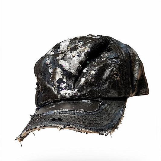 3d image of Black acid-washed denim hat with silver paint accents, multicolored rhinestones, and a ripped visor seam, customized by ASTROBOI* STUDIO.