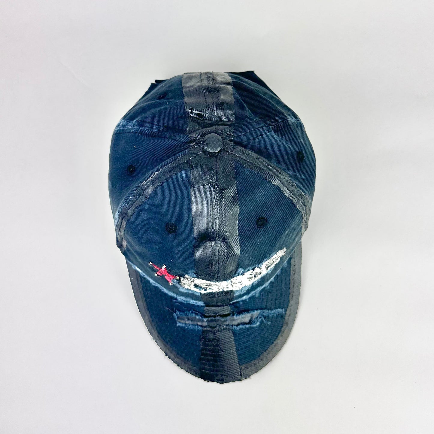 Top product shot of ASTROBOI* RBP navy and black distressed utility hat with deconstructed visor, rhinestone logo sealed in resin, adjustable strap, custom NYC piece