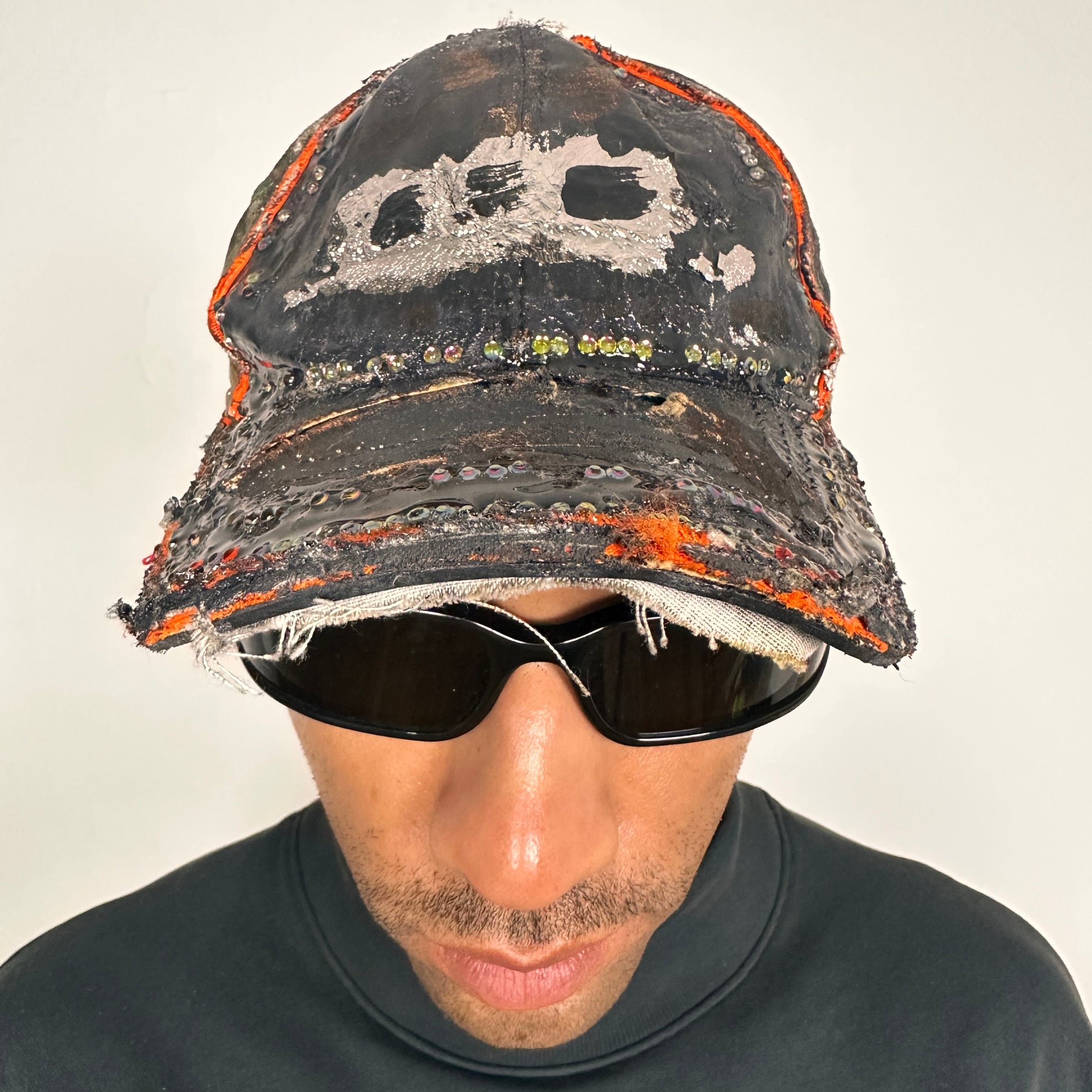 Overview of ASTROBOI* brown camouflage distressed hat with rhinestones sealed in clear resin and custom hand-painted detailing.