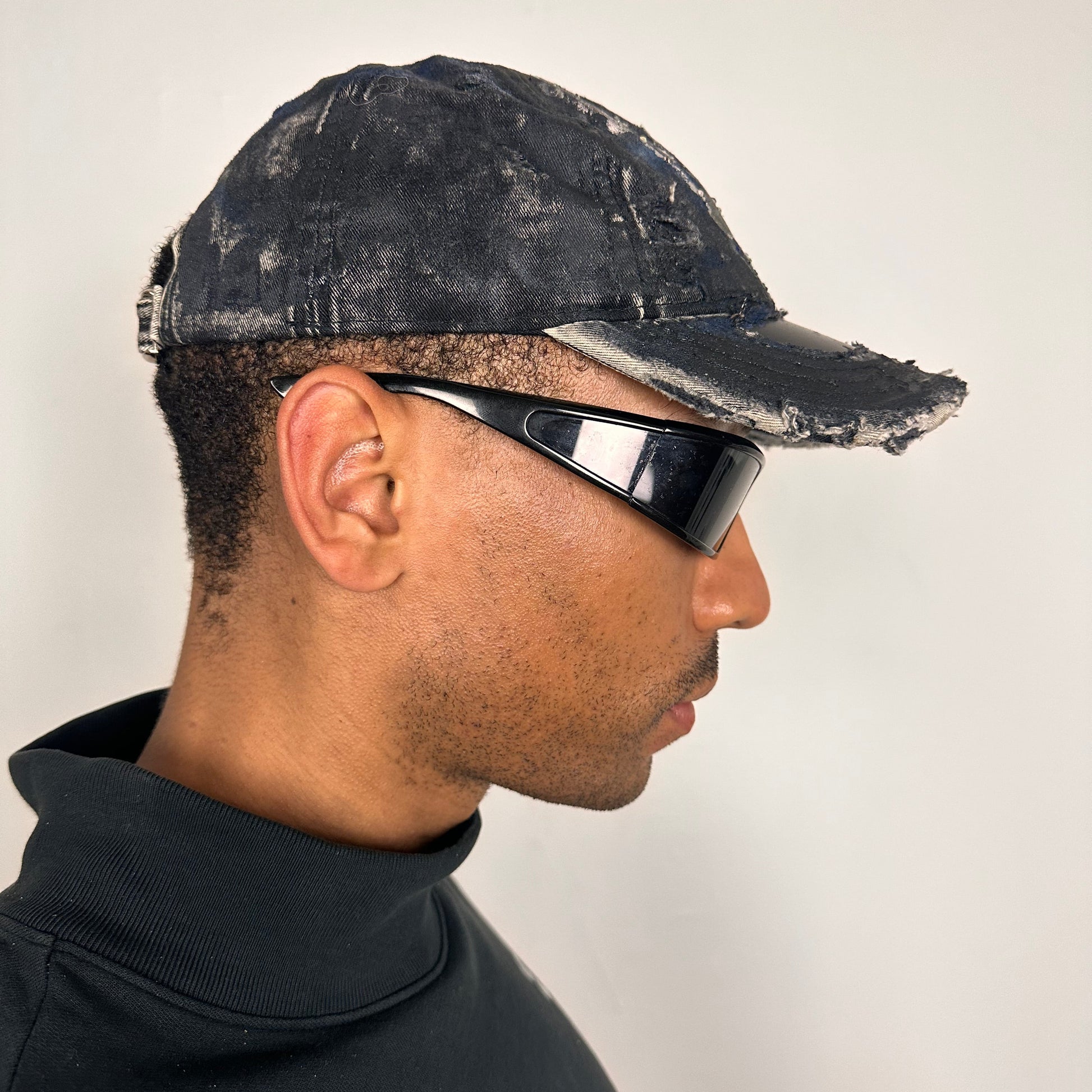 Right side of Black acid-washed denim hat with silver paint accents, multicolored rhinestones, and a ripped visor seam, customized by ASTROBOI* STUDIO.