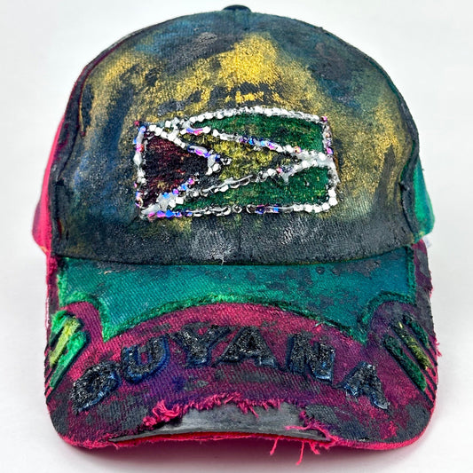 Front product short of ASTROBOI* Guyana yellow red green distressed baseball hat with resin-sealed rhinestone logo patch and adjustable strap, hand-customized in NYC