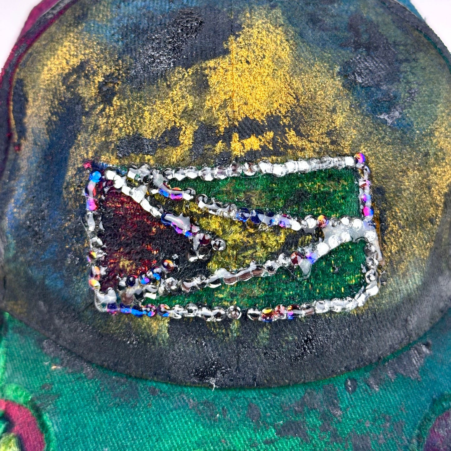 Flag close up of ASTROBOI* Guyana yellow red green distressed baseball hat with resin-sealed rhinestone logo patch and adjustable strap, hand-customized in NYC