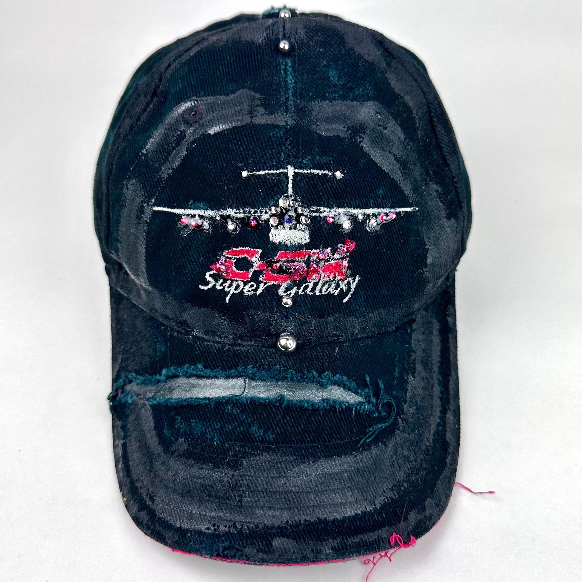 Front product shot of ASTROBOI* C5M Super Galaxy black baseball cap with resin-sealed rhinestone logo patch and adjustable strap, hand-customized in NYC