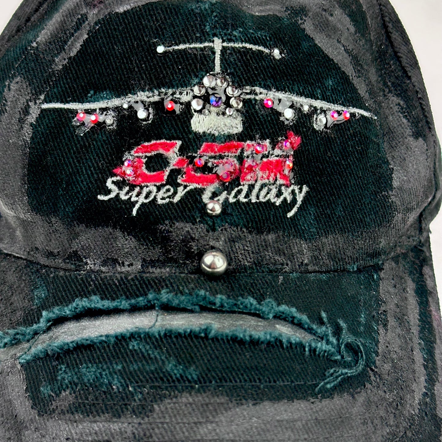 Close up cover shot of ASTROBOI* C5M Super Galaxy black baseball cap with resin-sealed rhinestone logo patch and adjustable strap, hand-customized in NYC