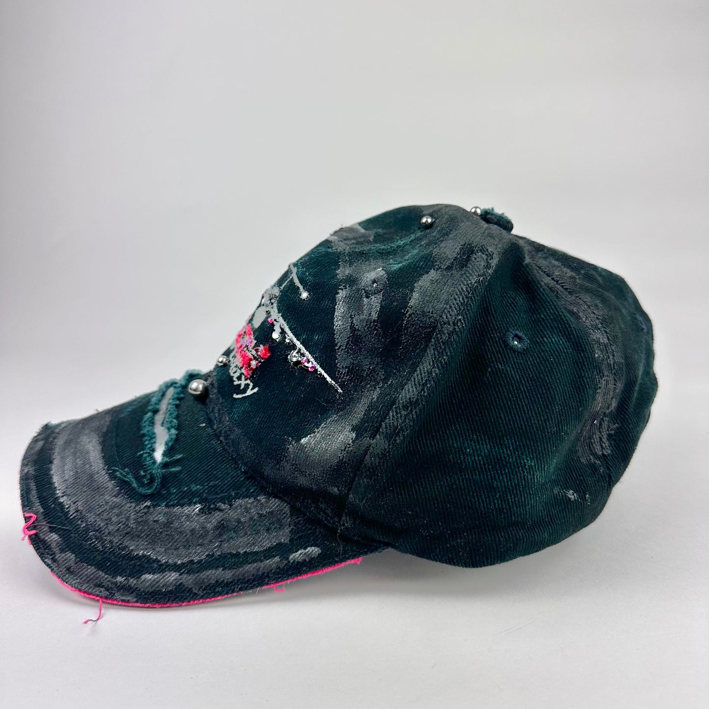 Left side cover shot of ASTROBOI* C5M Super Galaxy black baseball cap with resin-sealed rhinestone logo patch and adjustable strap, hand-customized in NYC
