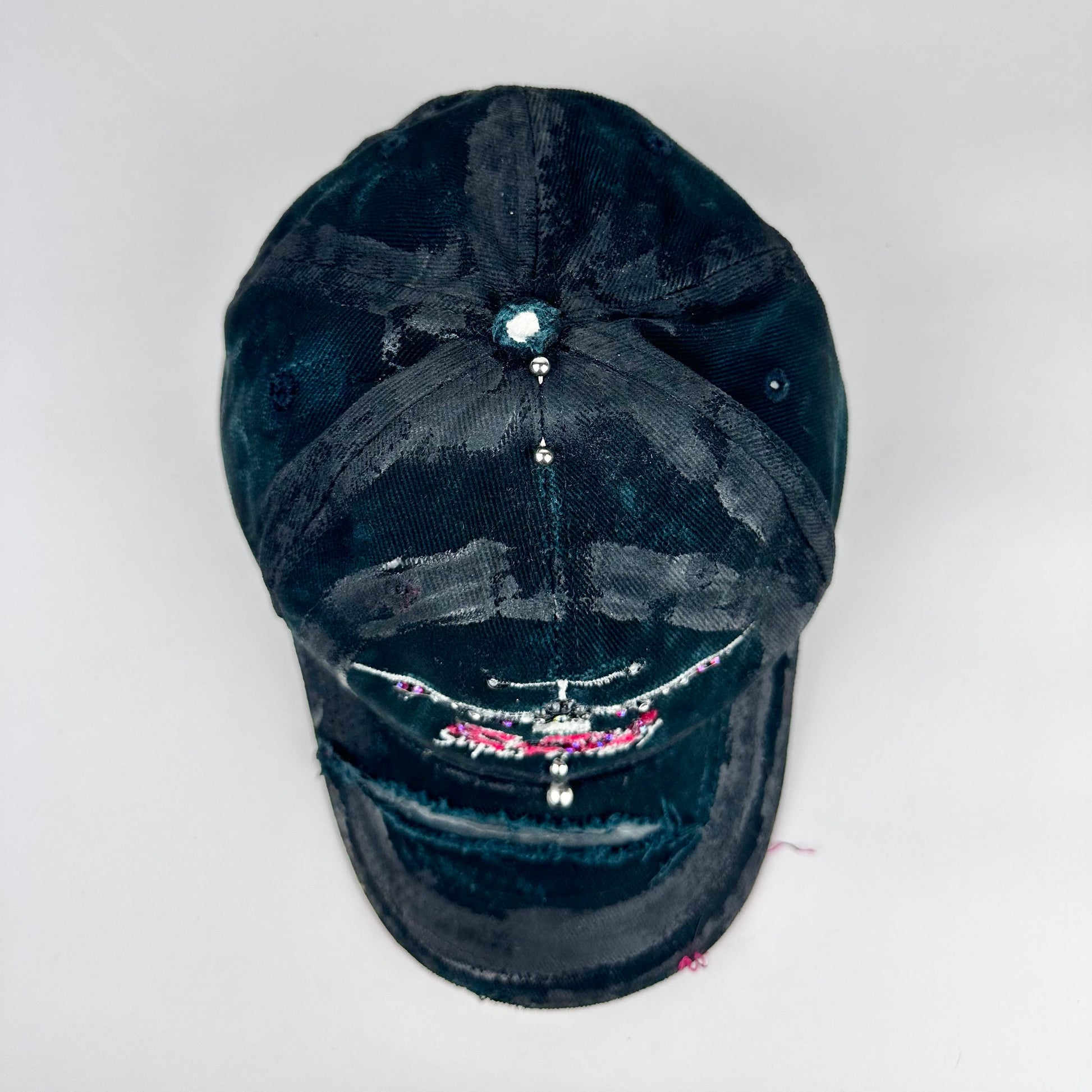 Top product shot of ASTROBOI* C5M Super Galaxy black baseball cap with resin-sealed rhinestone logo patch and adjustable strap, hand-customized in NYC
