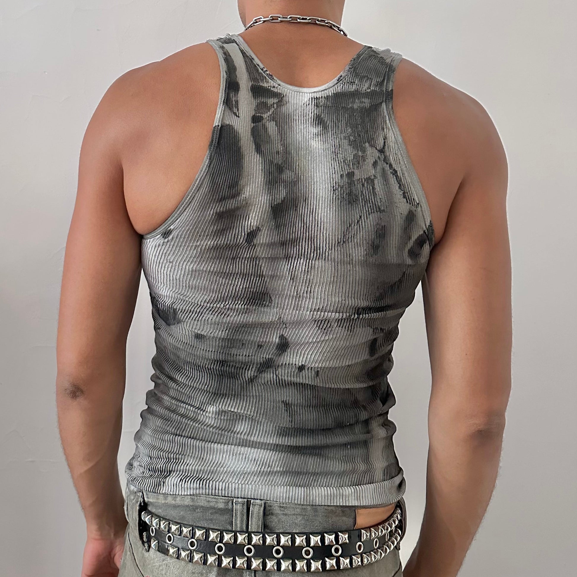 ASTROBOI* x Hanes 'Cobain' black and gray ribbed abstract graphic grunge tank top, rear view showing geometric faded design and raw hemline, worn by male model.