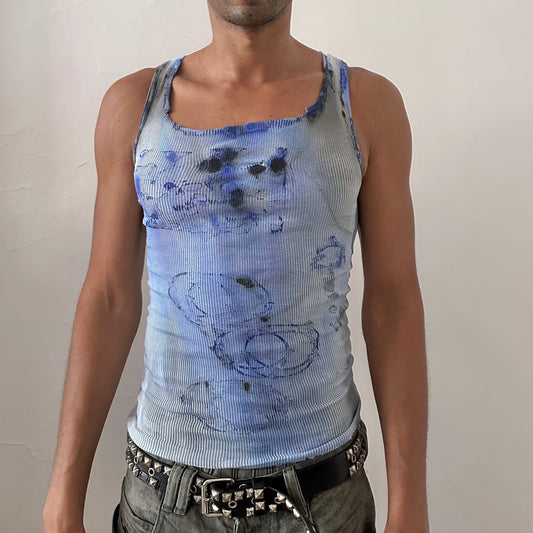 ASTROBOI* x Hanes 'Klein' white ribbed slim-fitting graphic tank top with blue and black tie dye faded abstract design, paint splatter effect, and raw neck and hemline, front view.