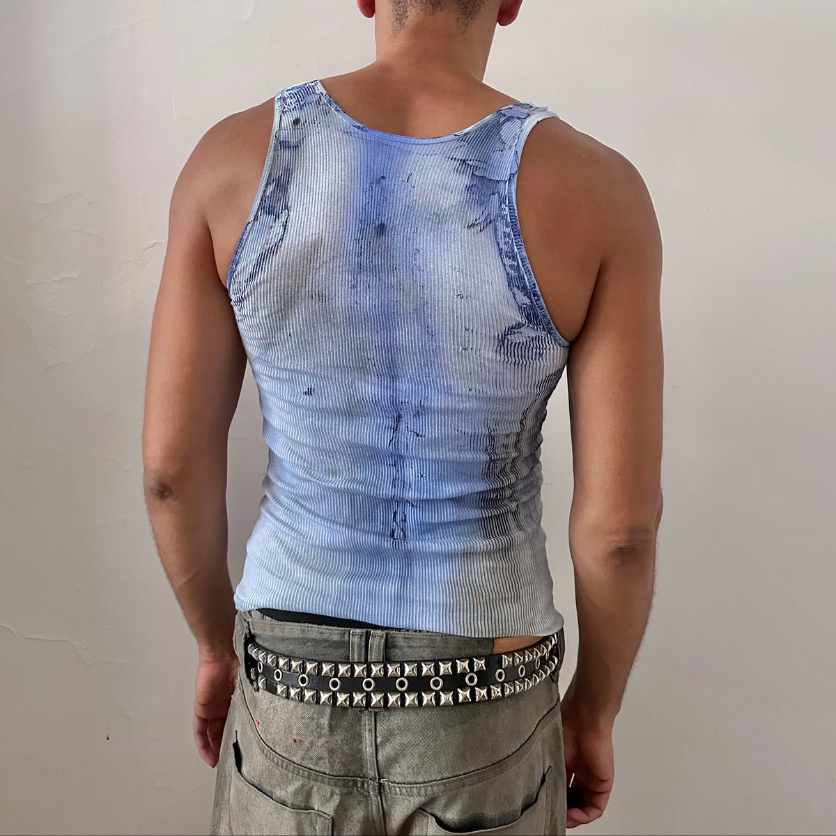 ASTROBOI* x Hanes 'Klein' blue ribbed graphic splatter and swirl tank top, rear view showing tie dye swirl design and raw hemline, worn by male model.