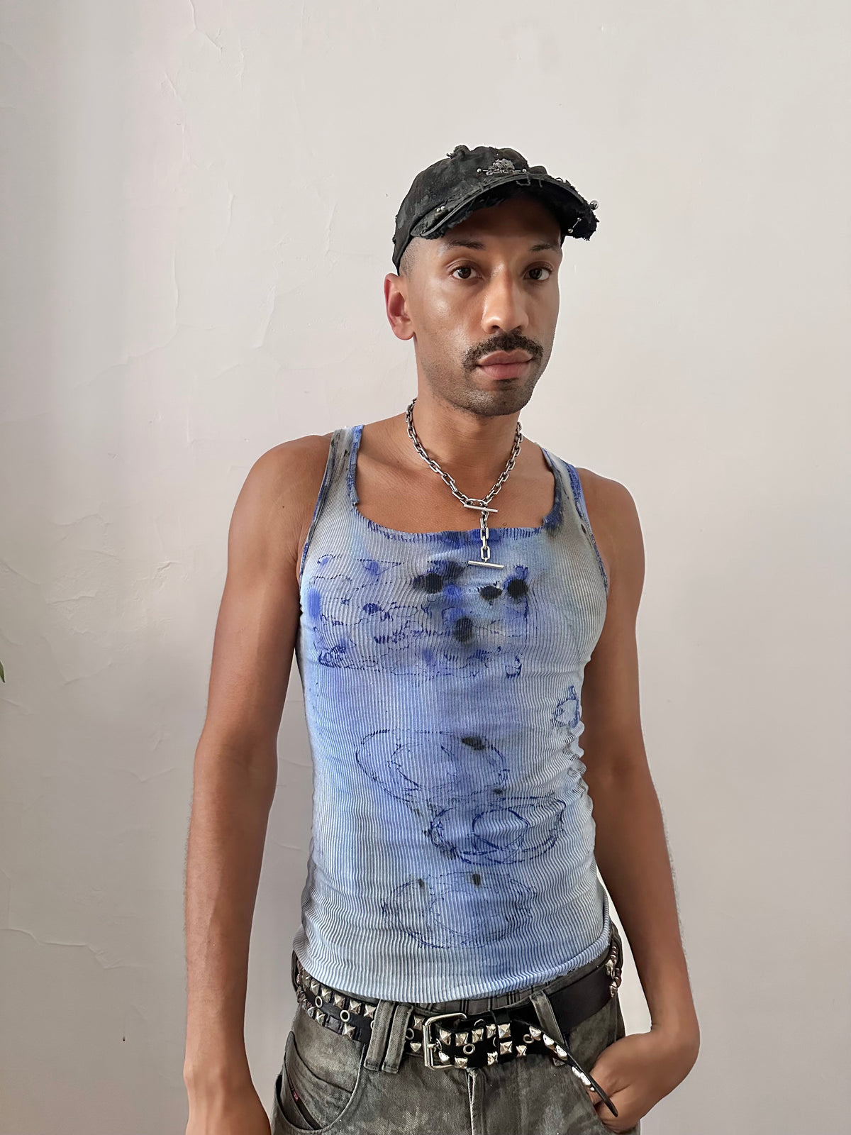 Male model wearing ASTROBOI* x Hanes 'Klein' blue ribbed graphic splatter and swirl tank top, styled full look, ASTROBOI* STUDIO NYC.
