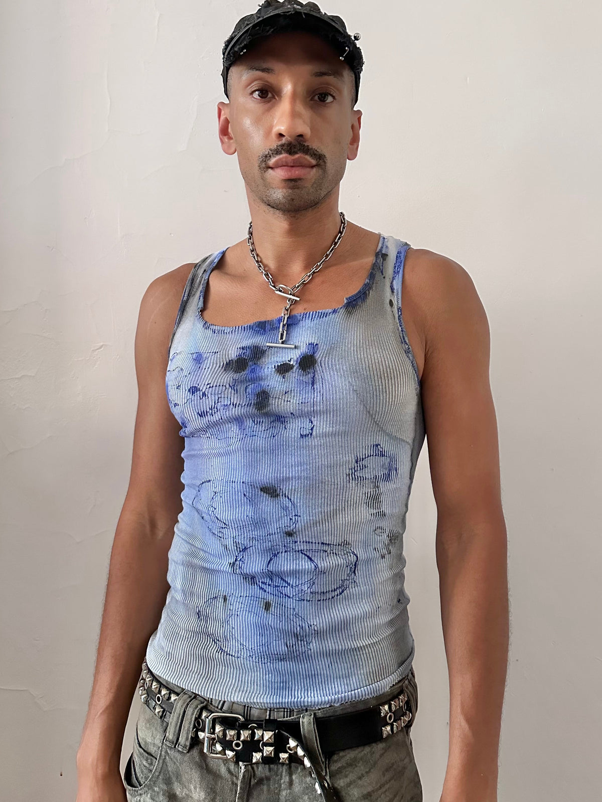 Male model wearing ASTROBOI* x Hanes 'Klein' blue ribbed graphic splatter and swirl tank top, styled full look, ASTROBOI* STUDIO NYC.
