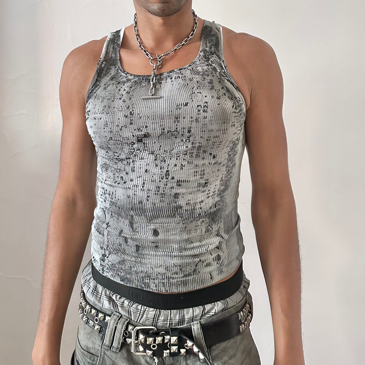 ASTROBOI* x Hanes 'Digi Camo' white ribbed Y2K slim-fitting graphic tank top with washed out black and white digital camo pattern, black faded stains, and raw hemline, front view.