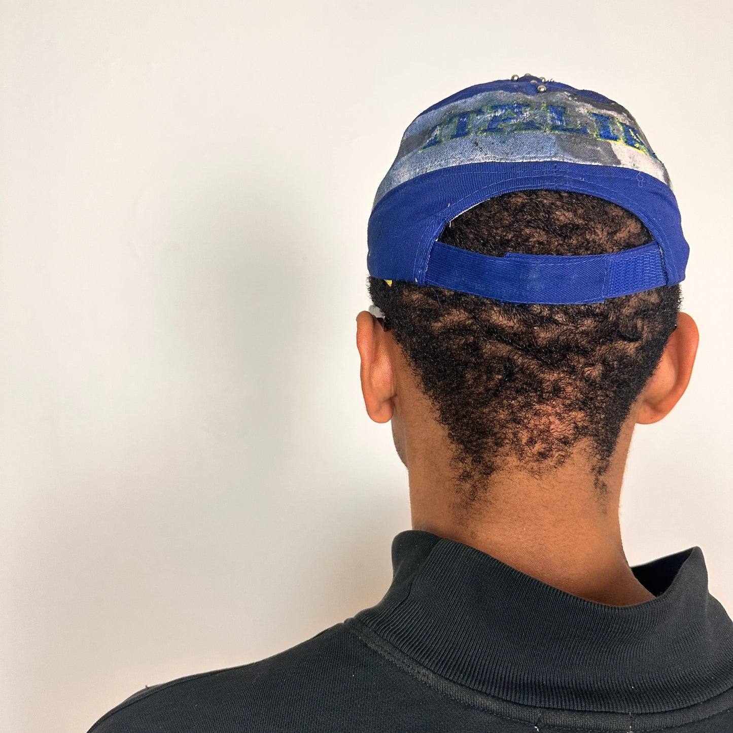 Back of Upcycled blue and white ASTROBOI* ‘ITALIA’ hat with rhinestones, resin, custom paint, and stainless steel piercings, handcrafted in NYC.