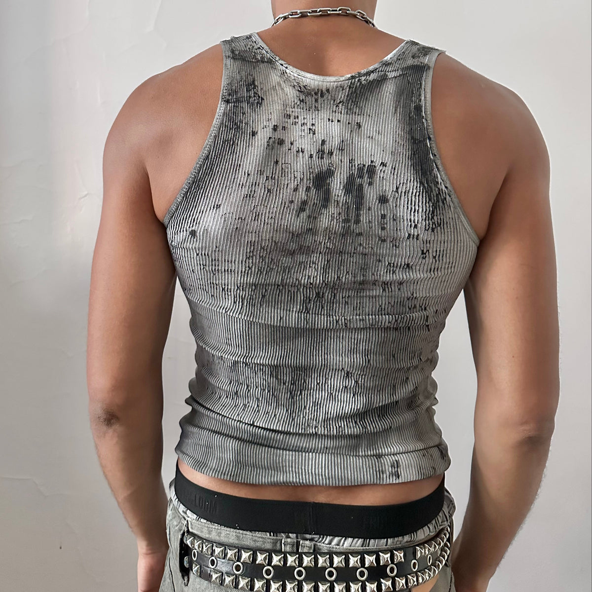 ASTROBOI* x Hanes 'Digi Camo' Y2K black and white ribbed graphic tank top, rear view showing digital camo pattern and raw hemline, worn by male model.