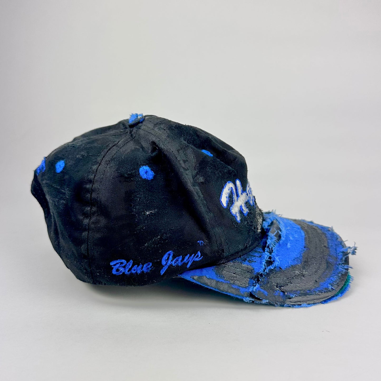 Blue Jays embroidered on the side of black and blue colored baseball cap 