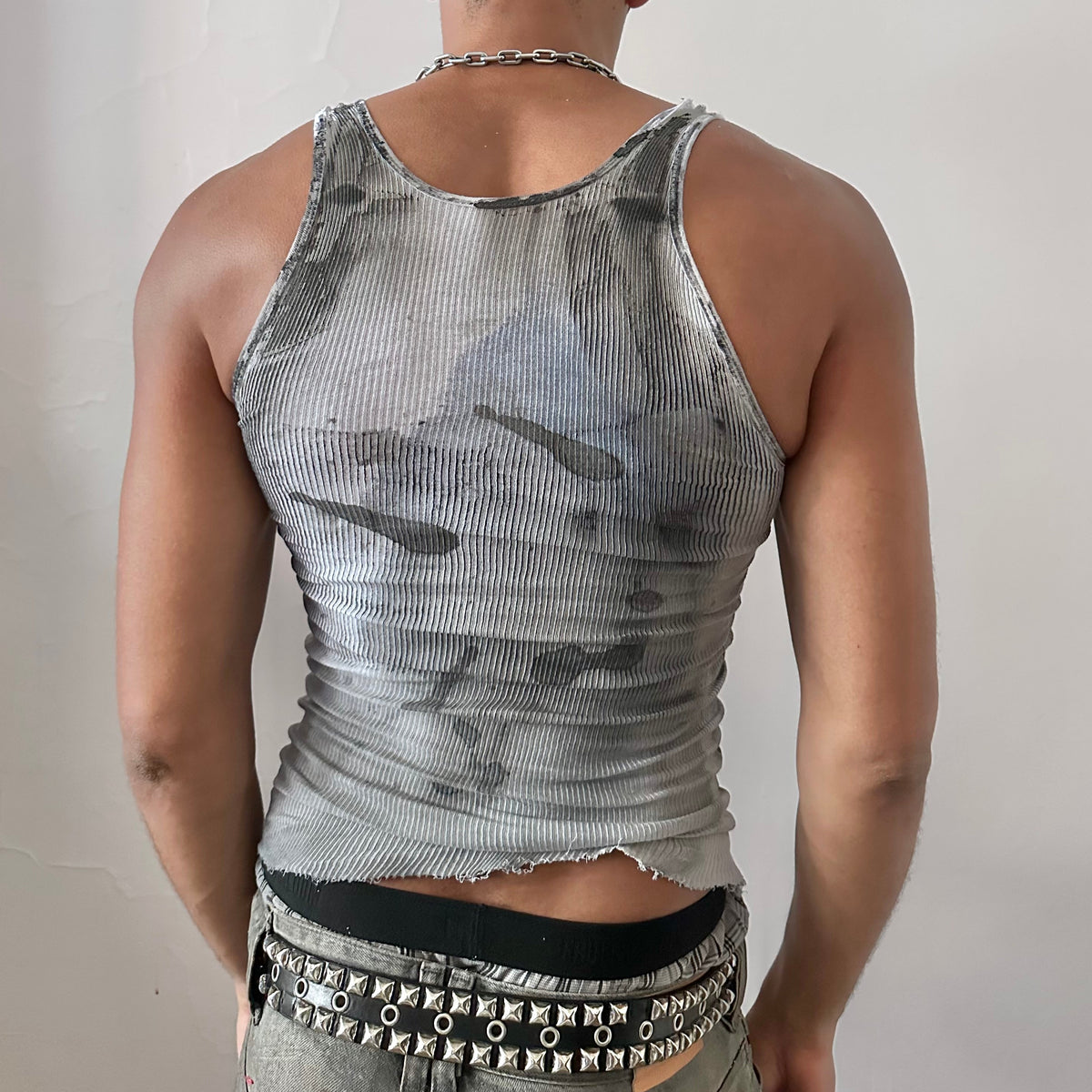 ASTROBOI* x Hanes 'Ice Dancer' white, black, and blue ribbed graphic tank top, rear view showing tribal tattoo print and raw hemline, worn by male model.