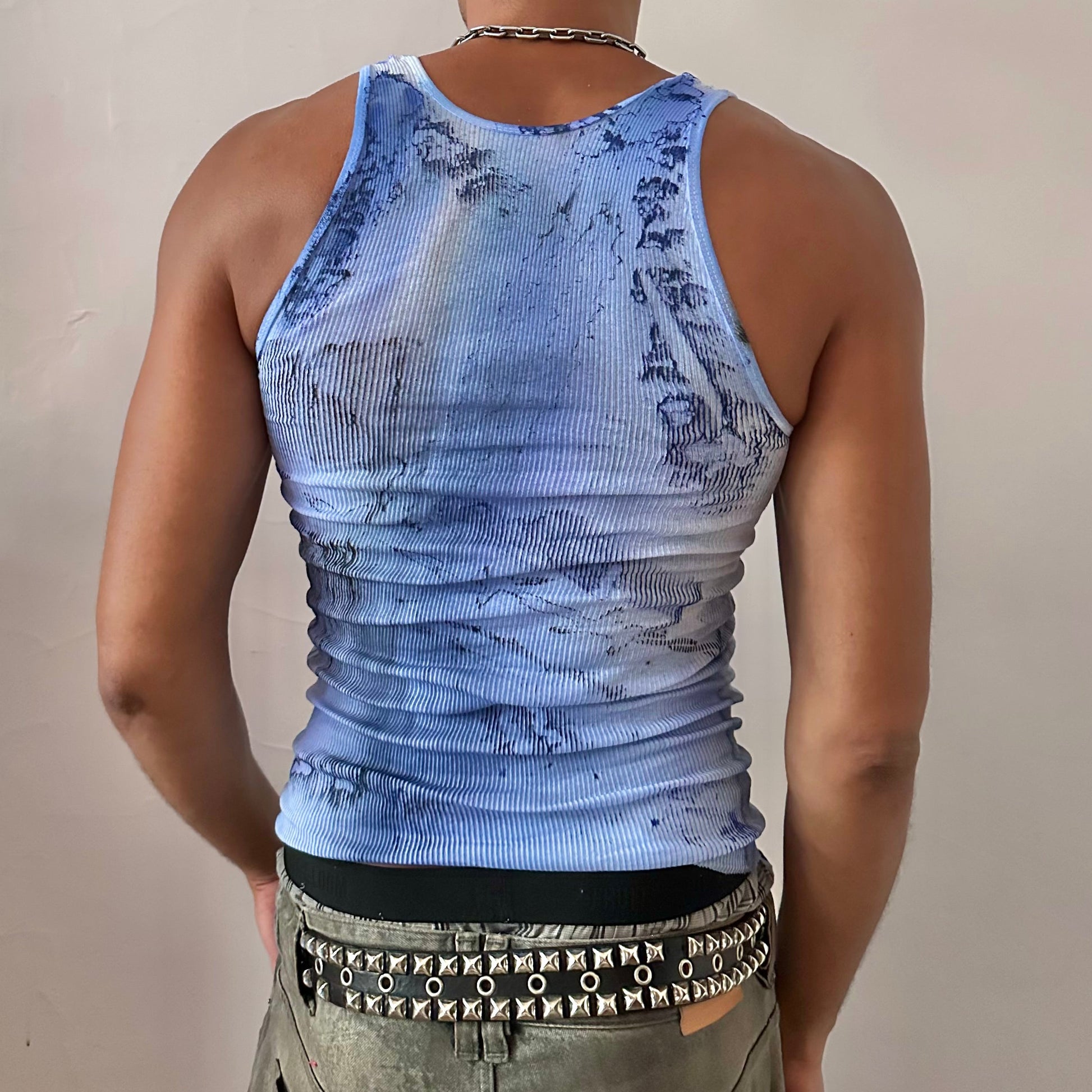 ASTROBOI* x Hanes 'Aero' blue ribbed graphic swirl tank top, rear view showing blue and black faded swirl design and raw hemline, worn by male model.