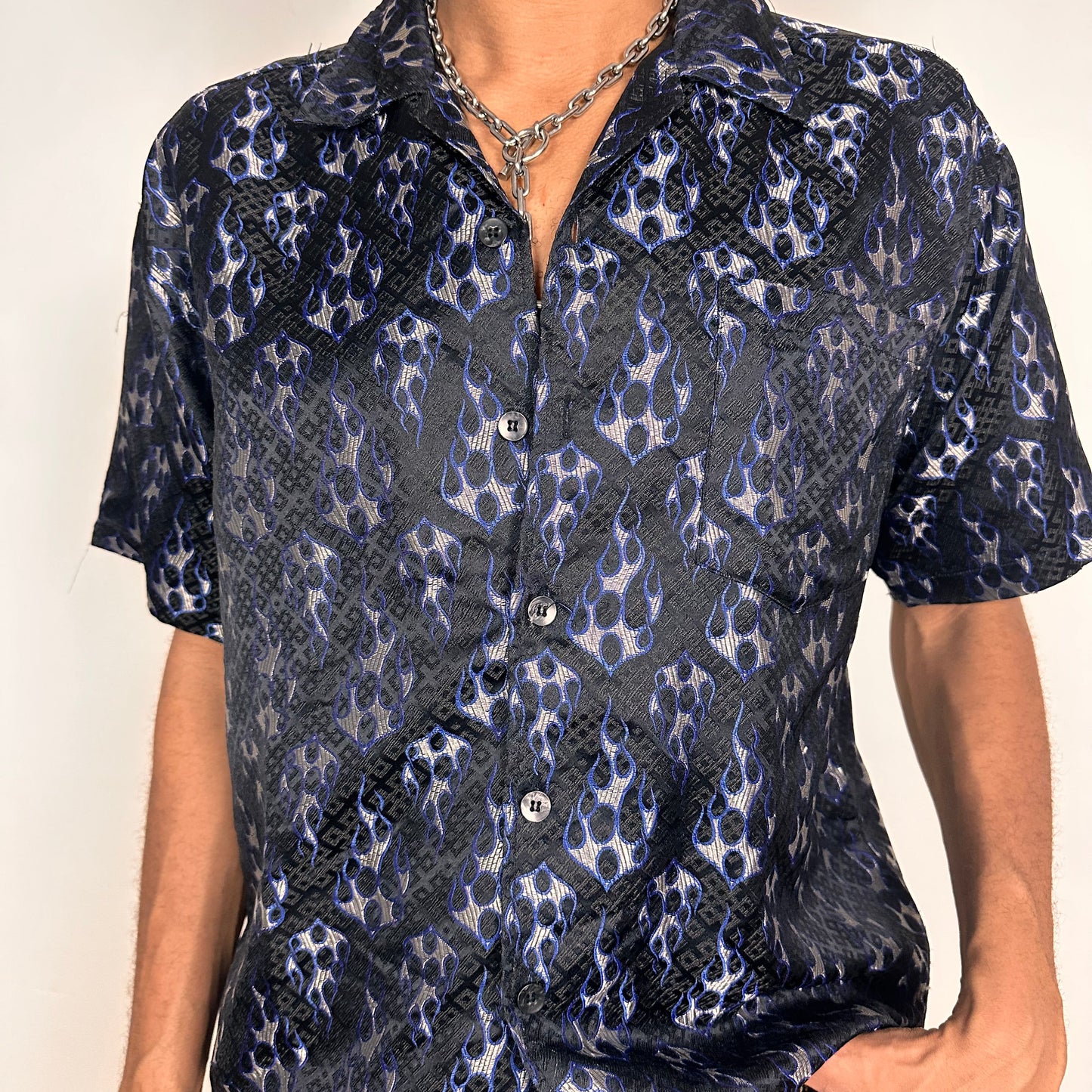 Front close up of Vintage ODO Y2K blue flame button-up shirt with silver and blue flame graphics and boxy fit
