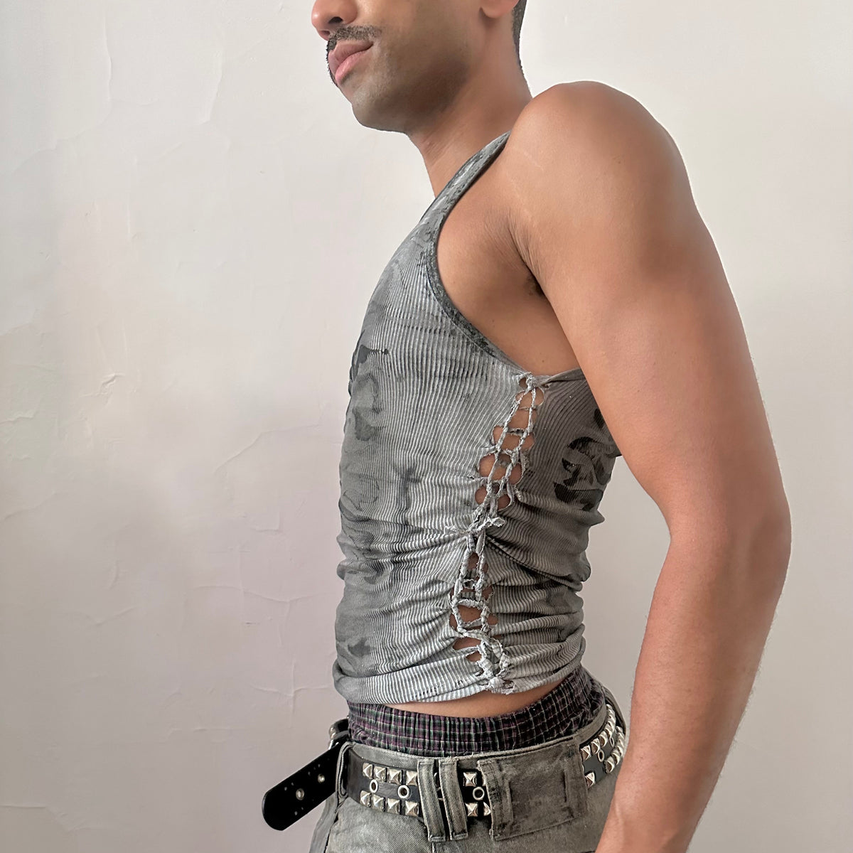 Left side detail of ASTROBOI* x Hanes 'Svartalfa' showing hand-painted black faded flame design and side braid detail on gray tank.