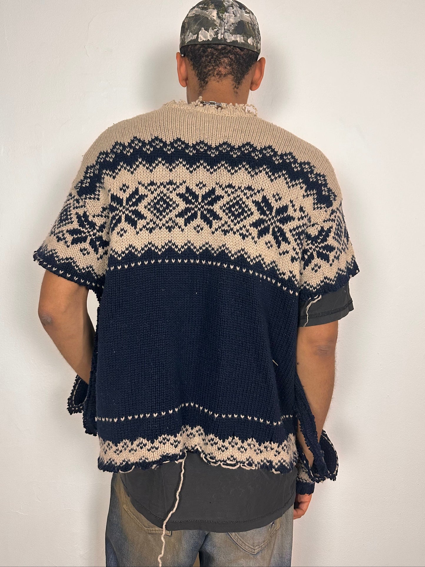 Back side of Deconstructed Fair Isle grunge sweater in XL with boxy fit, cutout sleeves, and raw hem, handmade by ASTROBOI* STUDIO in NYC.