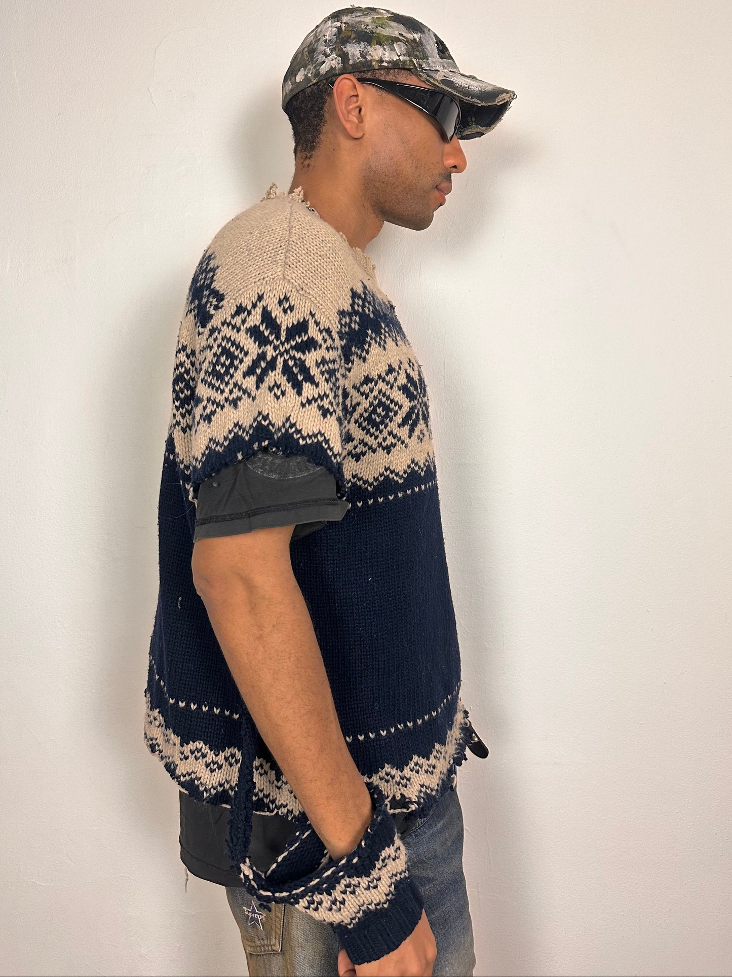 Right side of Deconstructed Fair Isle grunge sweater in XL with boxy fit, cutout sleeves, and raw hem, handmade by ASTROBOI* STUDIO in NYC.