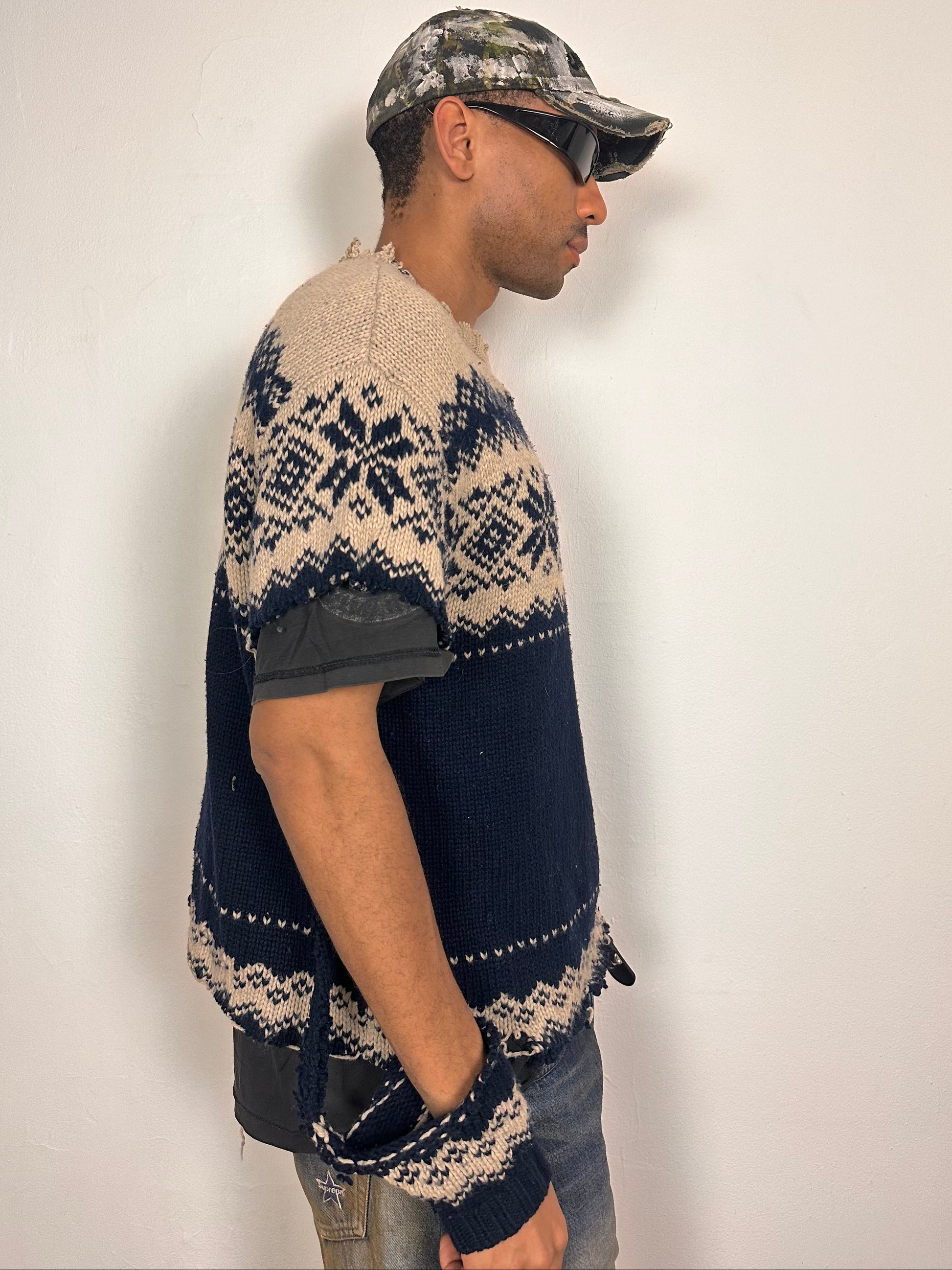 Right side of Deconstructed Fair Isle grunge sweater in XL with boxy fit, cutout sleeves, and raw hem, handmade by ASTROBOI* STUDIO in NYC.