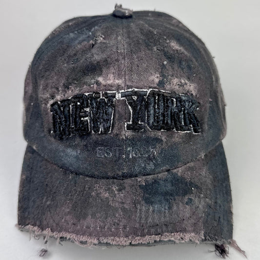 Front of ASTROBOI* New York brown and black distressed half-visor hat with bold logo, black paint accents, and deconstructed grunge design. Handmade in NYC.