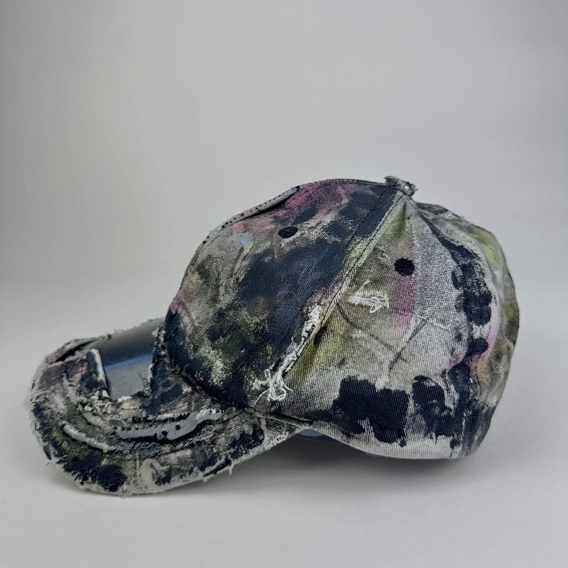 Distressed camouflage baseball cap on a white background