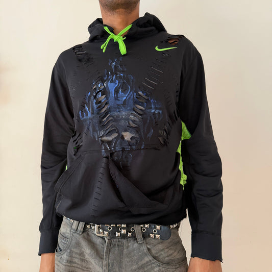 ASTROBOI* x Nike Pro black and green braided twist hoodie with blue faded flame design at chest, slashes along front body, green Nike check and drawstring, front view.
