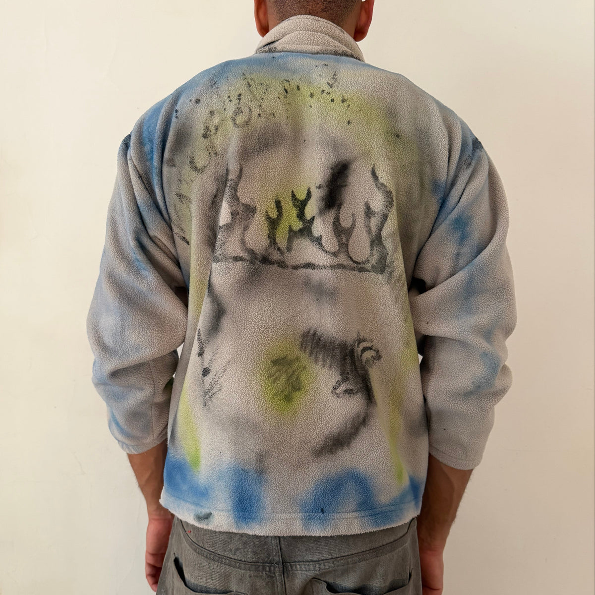 ASTROBOI* ‘Alaska’ Y2K tan tattoo print fleece zip up sweatshirt, rear view showing tattoo doodle and abstract print construction, worn by male model.