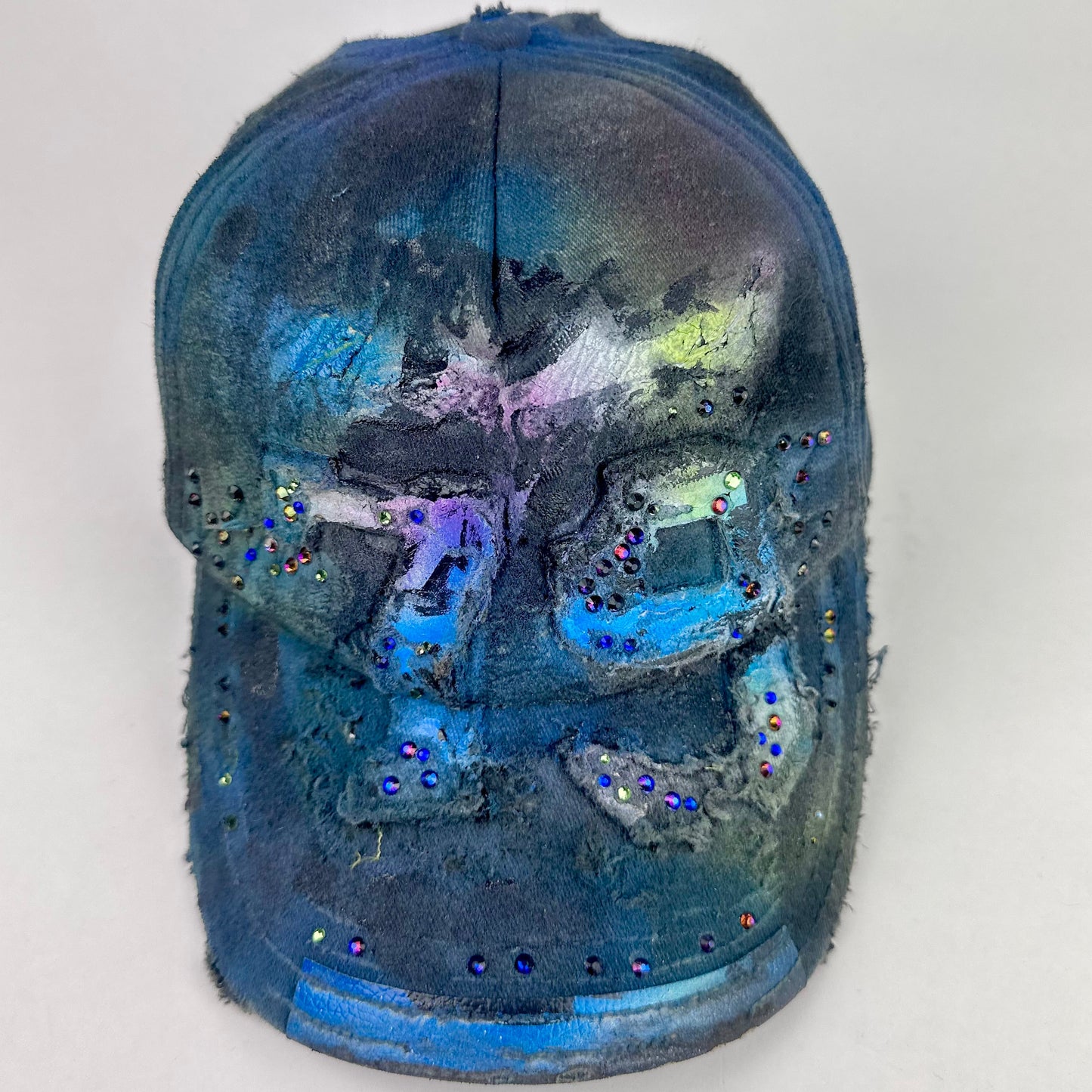 Front of ASTROBOI* 'Tropical 79' upcycled Y2K distressed hat featuring rainbow paint design, multicolored rhinestone embellishments, and hand-painted black shading for contrast, on a neutral background.