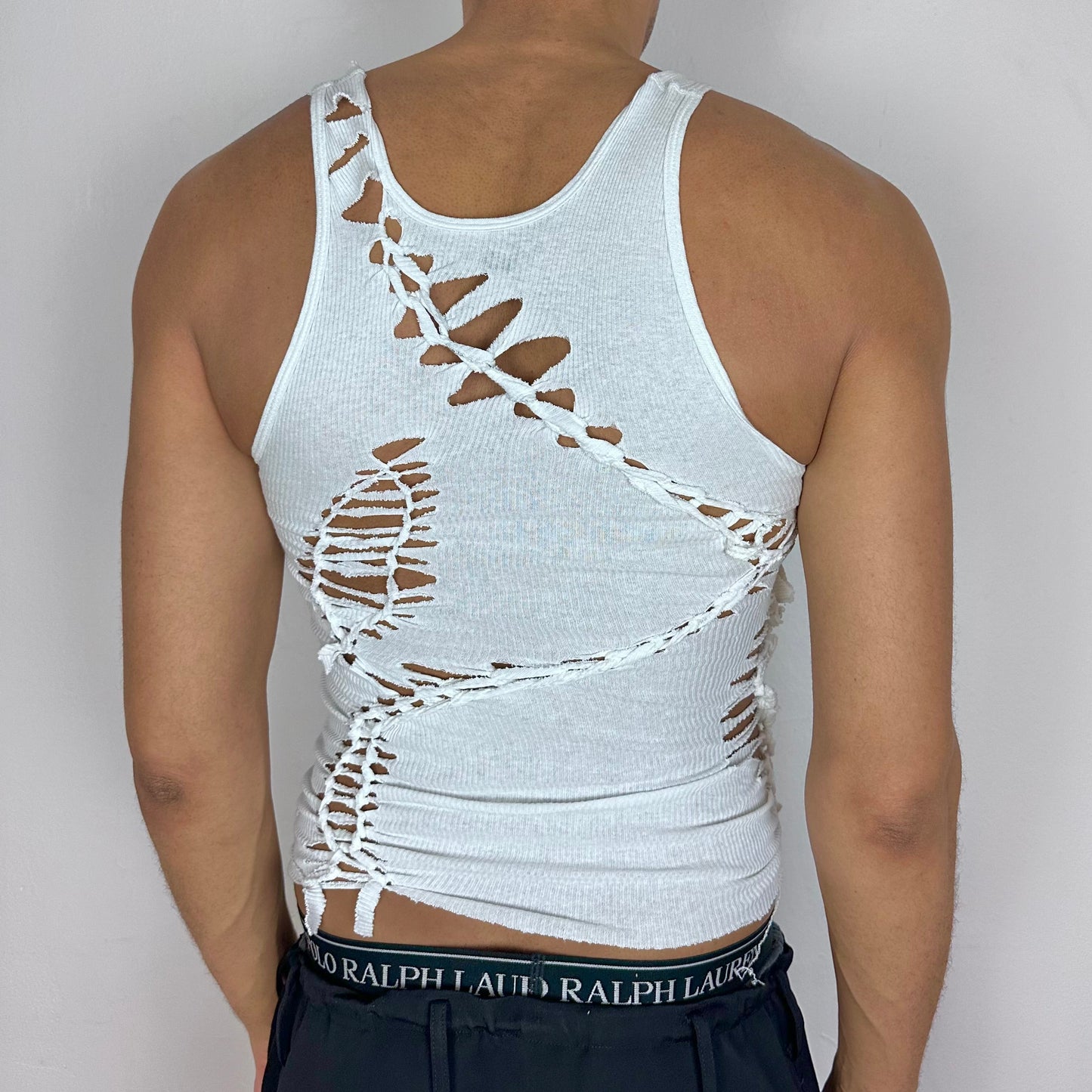 ASTROBOI* x Hanes 'Cosmo' white braided sleeveless tank top, rear view showing hand-braided back detailing, worn by male model.
